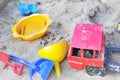 ChildrenÃ¢â¬Ës bright plastic toys in sandpit sand Royalty Free Stock Photo